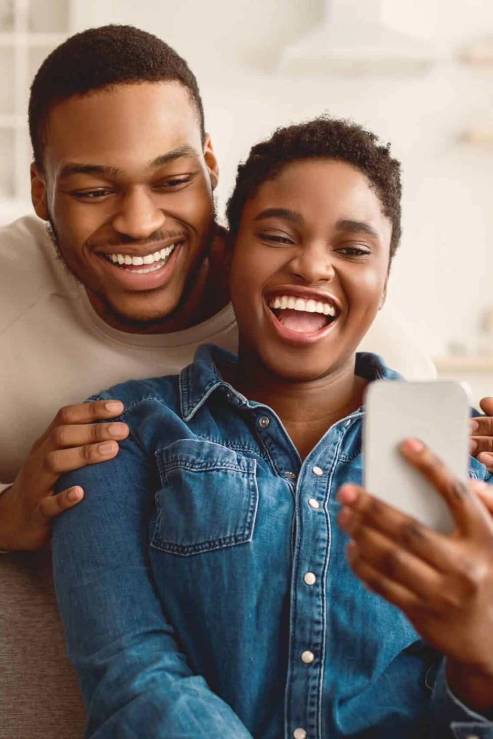 Smiling,Young,African,American,Man,Embracing,His,Woman,From,Behind